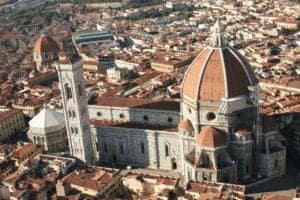 Aerial view of the Cathedral of Santa Maria del Fiore in Florence, Italy, showcasing its iconic dome and architectural details amidst the cityscape.