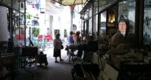 Cozy café interior with patrons enjoying drinks, showcasing a vibrant travel atmosphere and culinary experiences.