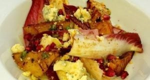 Colorful dish featuring roasted vegetables, pomegranate seeds, and crumbled cheese, representing culinary experiences for travel enthusiasts.