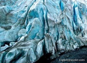 Close-up view of Exit Glacier's icy surface, showcasing blue and gray hues, highlighting the natural beauty of Kenai Fjords National Park.