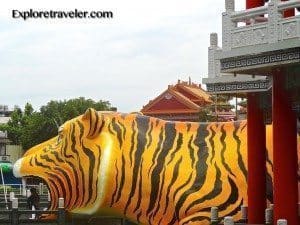 Tiger sculpture at the Tiger Pagoda in Lotus Lake, Kaohsiung, Taiwan, featuring vibrant orange and black stripes, representing a key attraction for travelers exploring the area.