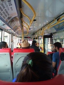 A group of people sitting at a train station - Bus
