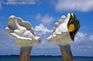 Sculpture of large seashells on a beach in Cijin District, Kaohsiung, Taiwan, representing local culture and attractions.