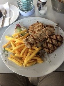 A plate of food on a table - French fries