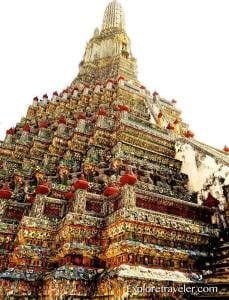 Hindu temple tower adorned with intricate carvings and vibrant colors, showcasing cultural significance in travel exploration.