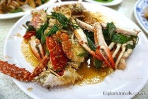 Chili crab dish featuring crabs, vibrant red chilies, and fresh herbs, showcasing a popular culinary experience in Taiwan inspired by Singaporean cuisine.