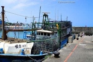 Ferry docked at a harbor with fishing nets, illustrating ferry travel and maritime experiences.