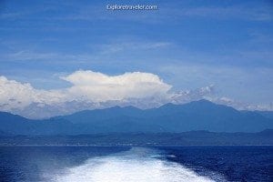 Scenic view of Mount Scenery on Green Island, showcasing blue skies and distant mountains over ocean waters, part of ExploreTraveler's travel content.