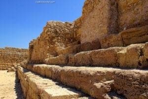 Ancient stone steps of a historical structure in Caesarea National Park, Israel, showcasing archaeological significance and the site's rich history.