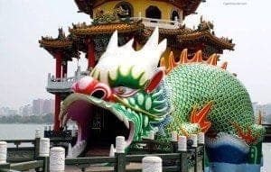 Dragon and Tiger Pagodas at Lotus Pond, featuring a vibrant green dragon entrance with intricate details and colorful architecture, symbolizing cultural significance in Taiwan.