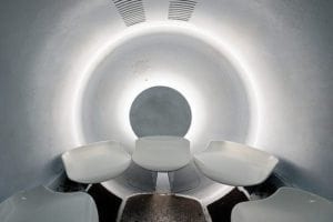 Aquadom interior view showcasing futuristic seating and circular design, highlighting the unique underwater experience in Berlin.