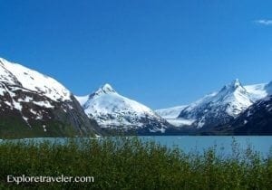 Fjord landscape with snow-capped mountains and turquoise water, showcasing natural beauty and travel inspiration from ExploreTraveler.