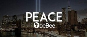 Skyscrapers illuminated at night with "PEACE" text overlay, showcasing urban architecture and city skyline.