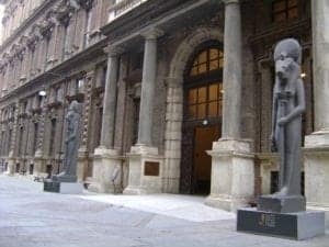 Egyptian Museum entrance featuring ancient statues and grand architecture, highlighting cultural heritage and historical significance.