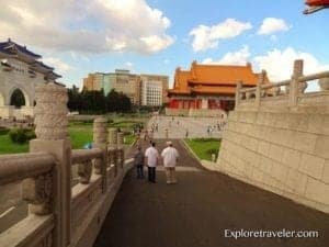 Pathway leading to the Chiang Kai Shek Memorial Hall in Taipei, Taiwan, with visitors walking and traditional architecture in the background, showcasing travel destination insights.