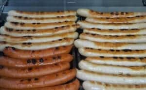 Grilled Frankfurter Würstchen, featuring a mix of traditional German sausages, highlighting culinary delights from the Rhine River region.