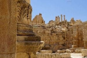 The Ancient Ruins Of Jerash - A large stone statue in front of a brick building - Ancient history