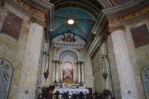 Interior view of Stella Maris Monastery featuring ornate architecture, colorful ceiling, and altar, highlighting travel insights on religious sites.