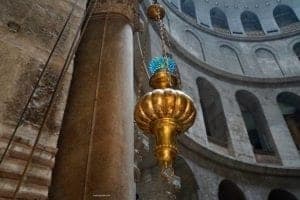 Christians Experience Holy Week In Jerusalem - A gold clock sitting on top of a building - Church of the Holy Sepulchre