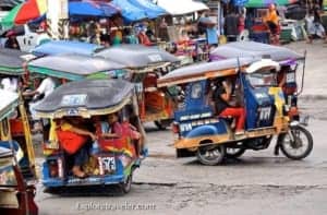 Colorful tricycles navigating a busy market street, showcasing local transportation options in vibrant travel destinations.