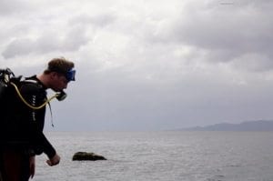 Diving Around The Beautiful Islands Of The Philippines - A man standing next to a body of water - Sea of Galilee