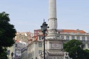 ExploreTraveler Presents: Exploring Lisbon Portugal Part 1 - A small clock tower in front of a building - Lisbon