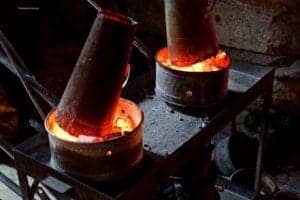 Traditional Turkish cookware with two metal pots over glowing embers, illustrating essential cooking techniques in Istanbul's culinary culture.