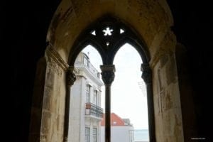 Exploring Sé de Lisboa Cathedral In Lisbon Portugal - A sign on the side of a building - Lisbon Cathedral