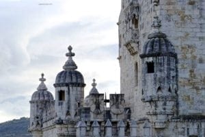 Discovering The Mysteries Of The Belem Tower In Lisbon Portugal - A group of people standing in front of a building - Belém Tower