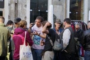 Group of people engaged in conversation during the SteemFest protest in Lisbon, Portugal, with visible tote bag featuring "Steem Fest."