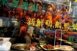 Display of roasted meats in a market stall on Tung Choi Street, Hong Kong, showcasing a variety of food options and vibrant local cuisine.