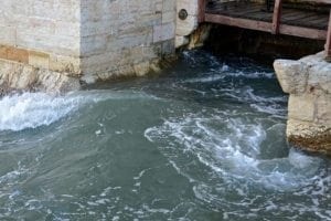 Water flowing near the base of the Belem Tower in Lisbon, highlighting its historical connection to water resources.