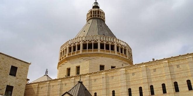 The Church Of The Annunciation In Nazareth, Israel - A large clock tower in front of a building - Basilica of the Annunciation