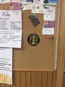 Bulletin board displaying various travel-related announcements, flyers, and a logo, highlighting the importance of sharing travel information and resources.