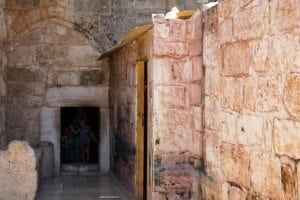 Church of the Nativity entrance in Bethlehem, showcasing ancient stone walls and doorway, highlighting its historical and cultural significance.