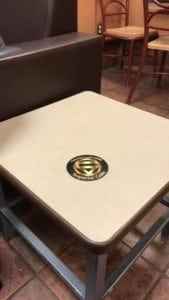 A chair sitting in front of a wooden table - Coffee Tables