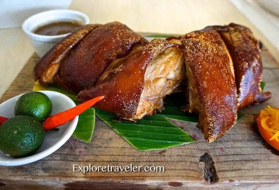 Eat Like A King And Travel The World - A plate of food on a table - Lechon