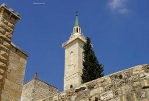 The Church of Saint John the Baptist ~ Birth Place Of John The Baptist - A large brick tower with a clock on the side of a building - Middle Ages