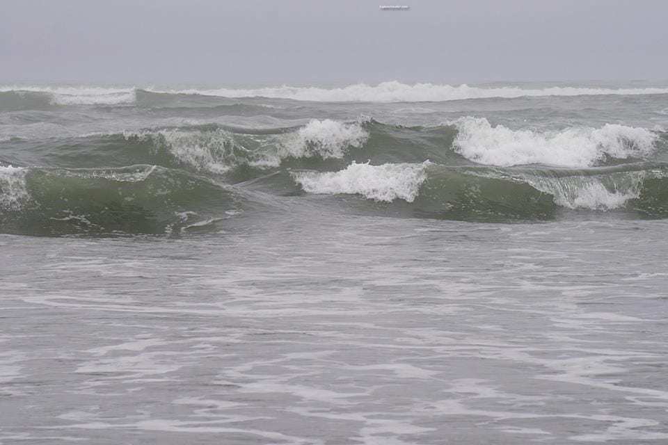 Photo Tour Of Central California Wine Country And Its Beaches - A person riding a wave on a surfboard in the ocean - Northern California