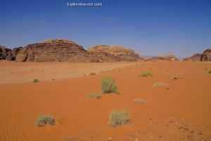 Desert landscape in Jordan showcasing red sand and rocky formations, highlighting the natural beauty for photography tours.