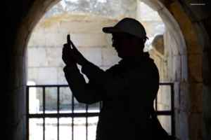 Silhouette of a tourist taking a photo inside an ancient archway at Agrippa Palace, Caesarea Philippi.