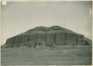Ur Ziggurat in ancient city of Ur, featuring visitors exploring the historical site against a barren landscape.