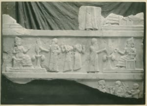 Relief sculpture depicting figures from the ancient civilization of Ur, showcasing seated deities, attendants, and ceremonial scenes, as featured in the Ur Online Photograph Collection.