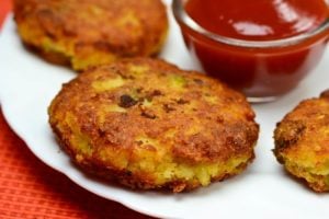 Aloo Tikki, popular Indian snack, golden-brown patties served with ketchup on a white plate, highlighting culinary tradition during lockdown.