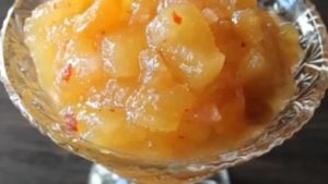 Apple chutney in a decorative glass bowl, featuring a chunky texture with hints of spice, aligning with the Indian cuisine recipe focus during lockdown.