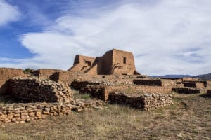 Ancient adobe ruins at Pecos National Historical Park, showcasing historical architecture and surrounding landscape in New Mexico.