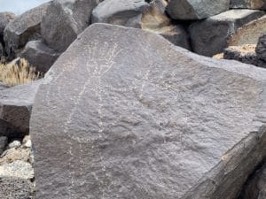 Human petroglyph on rock at Albuquerque's Petroglyph National Monument, showcasing ancient cultural art and historical significance.