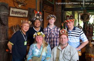 Group of six individuals wearing traditional Paiwan headdresses, showcasing cultural attire in a vibrant setting, reflecting the heritage of the Paiwan people in Taiwan.