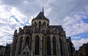Gothic-style Basilica with intricate architecture and a prominent spire under a cloudy sky, representing travel insights for ExploreTraveler.
