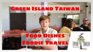 Young man seated at a table in a restaurant, with text overlay highlighting "Green Island Taiwan," "Food Dishes," and "Foodie Travel," showcasing culinary experiences from Green Island, Taiwan, for ExploreTraveler's audience.